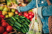 Vegetables and fruit in reusable bag on a farmers market, zero waste concept
