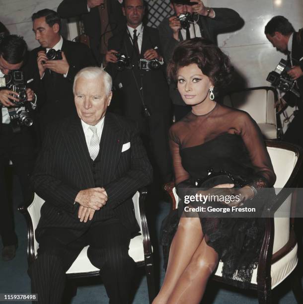 Actor and director Sir Charlie Chaplin with Italian actress Sophia Loren at the Savoy Hotel in London, UK, 1st November 1965. They are announcing...
