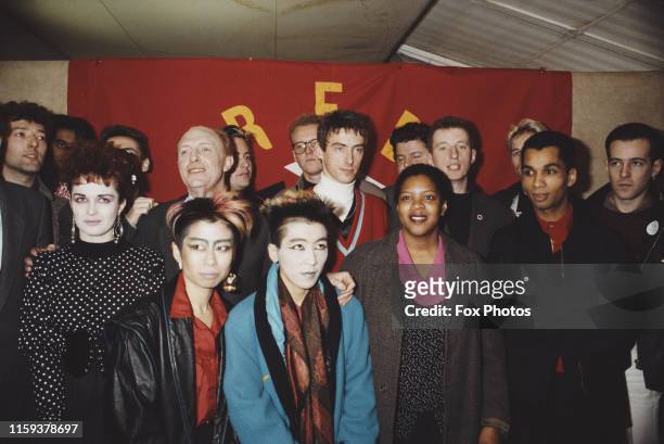 British politician Neil Kinnock, Leader of the Labour Party, poses with singers Paul Weller and Billy Bragg at the launch of the media group Red...