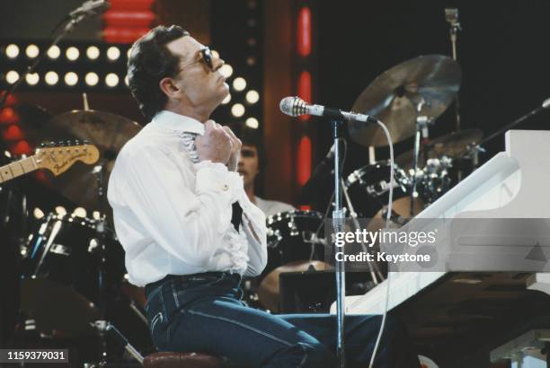 American singer, songwriter and musician Jerry Lee Lewis in concert, 11th April 1982.