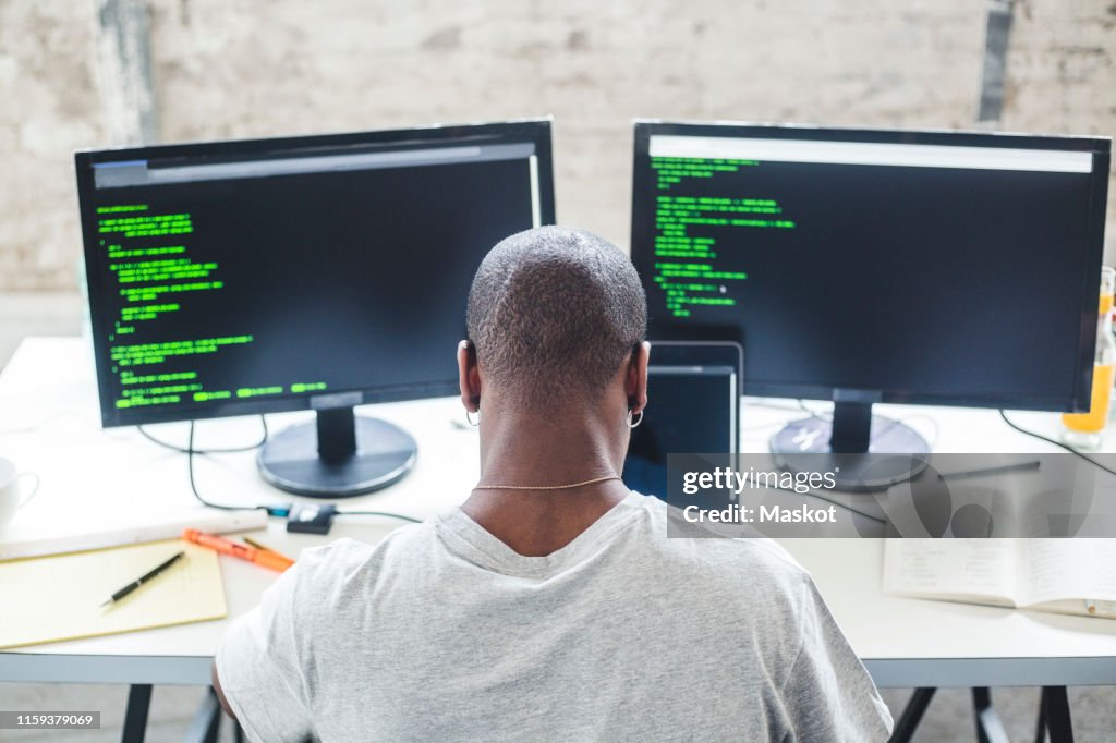 High Angle View Of Shaved Head Computer Programmer Programming Codes At ...