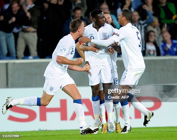 Daniel Welbeck of England is congratulated by teammates Jordan Henderson and Chris Smalling after scoring against Spain during their UEFA Under 21...