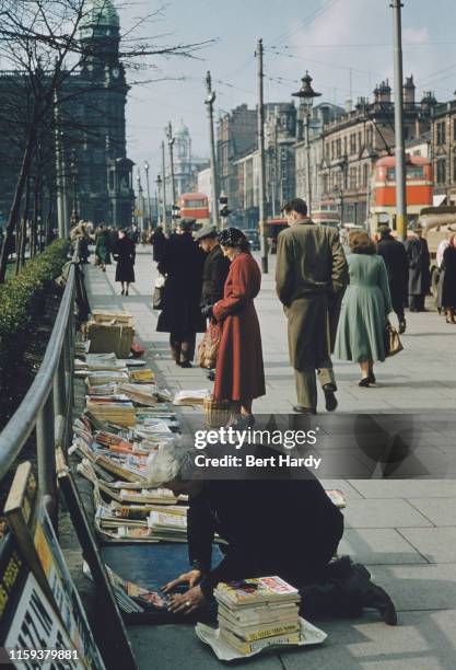 Man selling books and magazines in the street in Belfast, Northern Ireland, June 1955. Original Publication : Picture Post - 7825 - Belfast - pub....