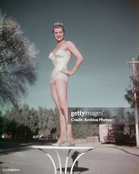 American actress and swimmer Esther Williams in a sequinned swimsuit and tiara, circa 1950.