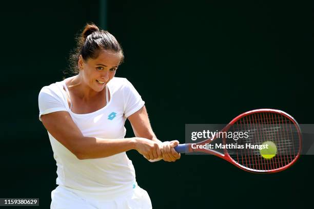 Viktoria Kuzmova of Slovakia plays a backhand during the Ladies' Singles first round match against Polona Hercog of Slovenia during Day one of The...