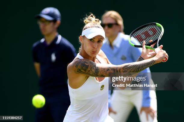 Polona Hercog of Slovenia plays a shot in her Ladies' Singles first round match against Viktoria Kuzmova of Slovakia during Day one of The...