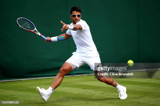 Janko Tipsarevic of Serbia plays a forehand in his Men's Singles first round match against Yoshihito Nishioka of Japan during Day one of The...