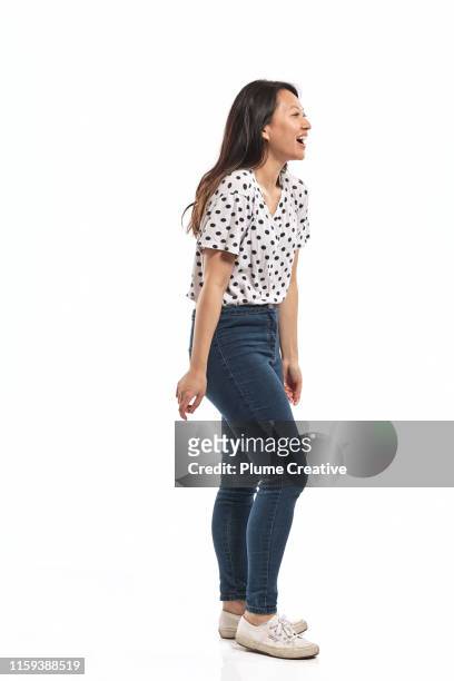 portrait of a young woman in studio - man side standing stock-fotos und bilder