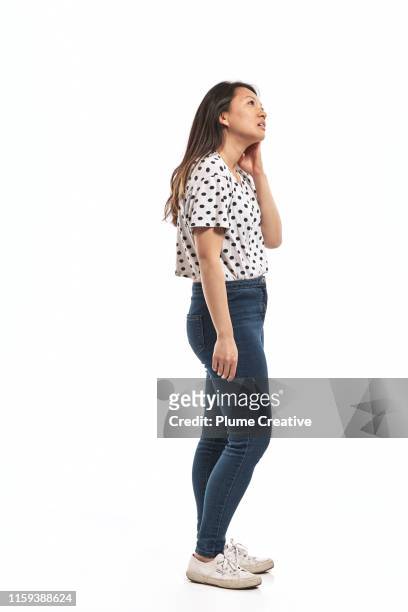 portrait of a young woman in studio - looking up stock pictures, royalty-free photos & images