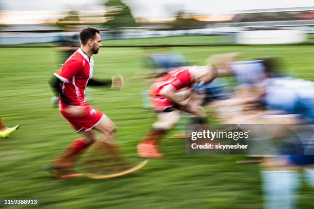 large group of rugby players running on a match in blurred motion. - rugby league field stock pictures, royalty-free photos & images