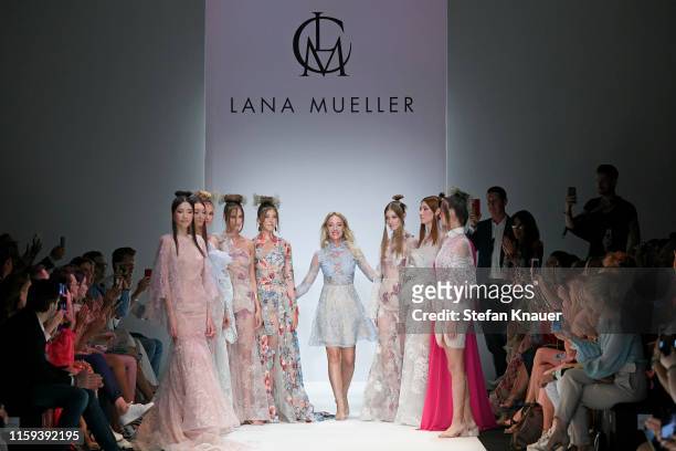 Designer Lana Mueller and Paulina Swarovski acknowledges the applause of the audience after the Lana Mueller show during the Berlin Fashion Week...
