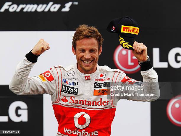 Jenson Button of Great Britain and McLaren celebrates on the podium after winning the Canadian Formula One Grand Prix at the Circuit Gilles...