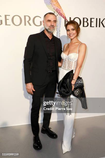 Cheryl and Georges Hobeika pose backstage after the Georges Hobeika Haute Couture Fall/Winter 2019 2020 show as part of Paris Fashion Week on July...