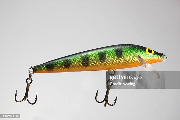 fishing lure on gray background - vishaak visgerei stockfoto's en -beelden