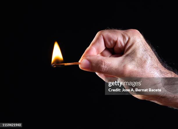 hand of a man, flame and smoke of match on black background. - match lighting equipment stock pictures, royalty-free photos & images