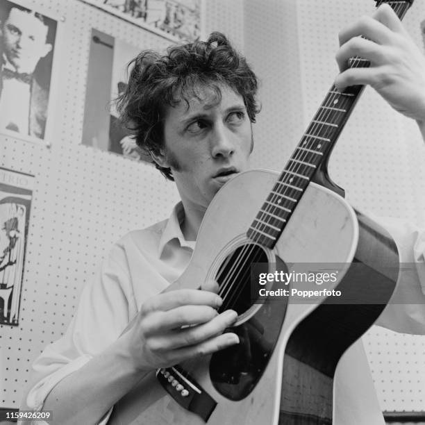 Scottish folk musician, singer and guitarist Bert Jansch pictured playing an acoustic guitar in London in June 1965.