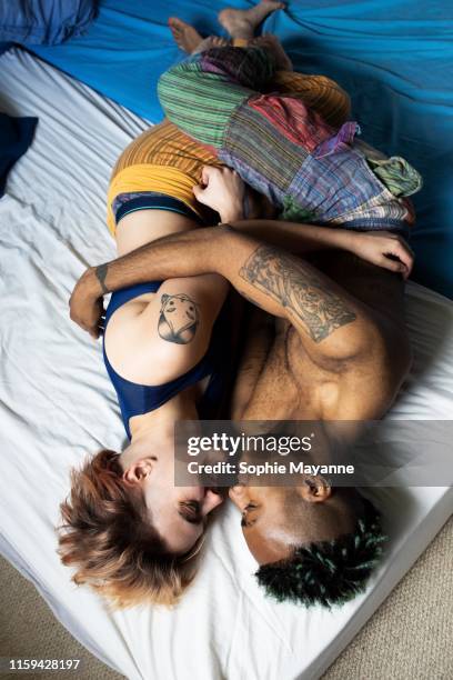 A young LGBT couple hugging in bed