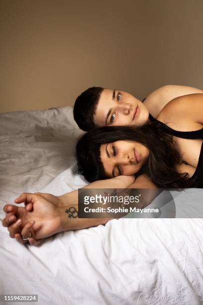 A young LGBT couple lying in bed together