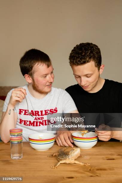 A young LGBT couple eating breakfast