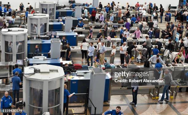 Airplane passengers line up for TSA security screenings at Denver International Airport in Denver, Colorado.