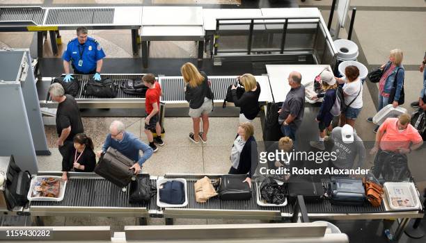 Airplane passengers line up for TSA security screenings at Denver International Airport in Denver, Colorado.