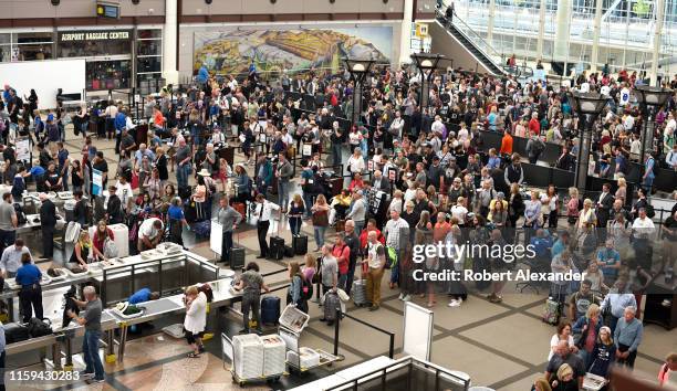 Airplane passengers line up for TSA security screenings at Denver International Airport in Denver, Colorado.