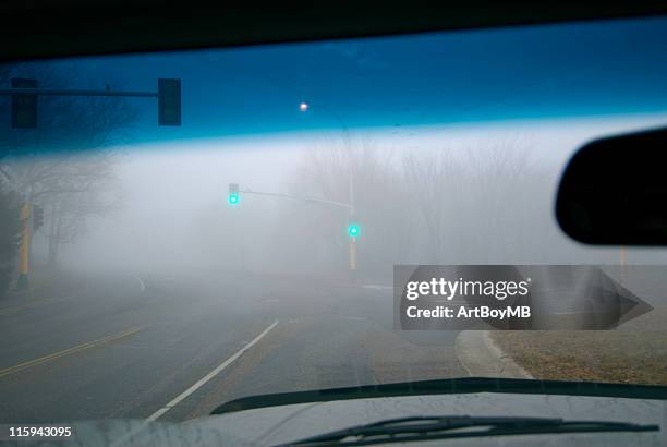 fog through windshield - driving in fog stock pictures, royalty-free photos & images