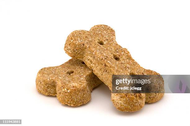 closeup of two processed dog bone shaped dog treats - dog treat stock pictures, royalty-free photos & images