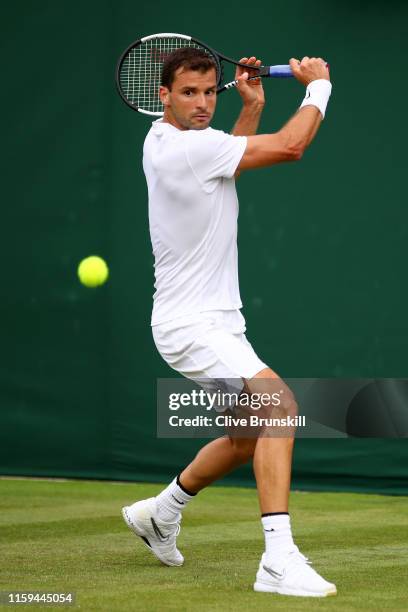 Grigor Dimitrov of Bulgaria plays a backhand in his Men's Singles first round match against Corentin Moutet of France during Day one of The...
