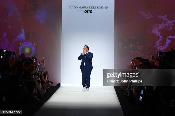 Designer Guido Maria Kretschmer acknowledges the applause of the audience after his show during the Berlin Fashion Week Spring/Summer 2020 at ewerk...