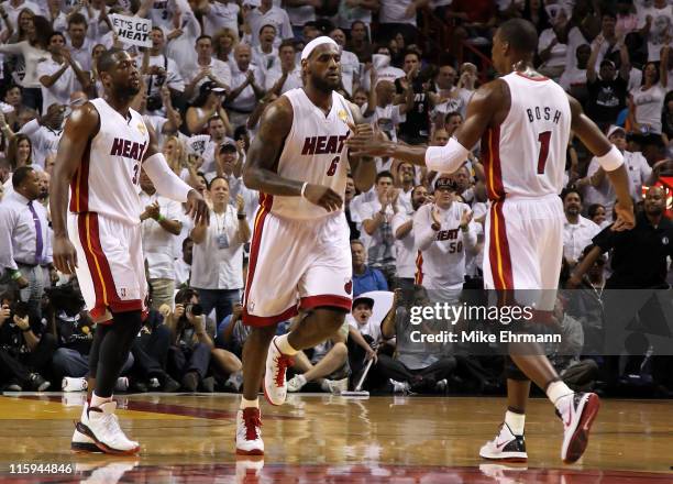 Dwyane Wade, LeBron James and Chris Bosh of the Miami Heat react on court against the Dallas Mavericks in Game Six of the 2011 NBA Finals at American...