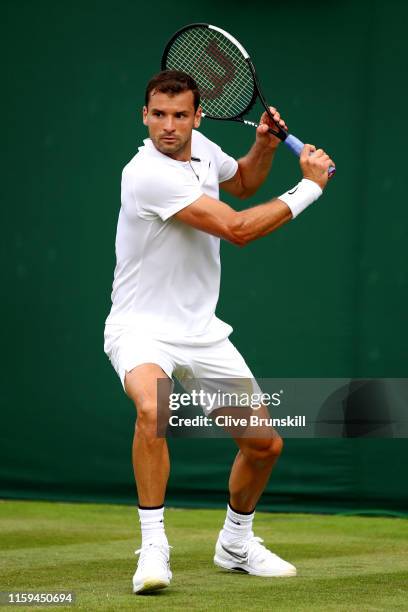 Grigor Dimitrov of Bulgaria plays a backhand in his Men's Singles first round match against Corentin Moutet of France during Day one of The...