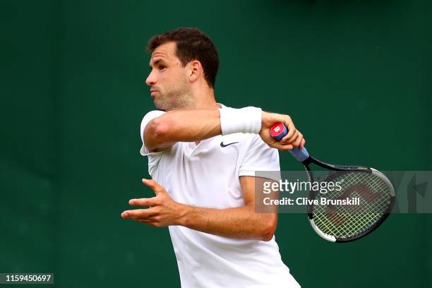 Grigor Dimitrov of Bulgaria plays a forehand in his Men's Singles first round match against Corentin Moutet of France during Day one of The...
