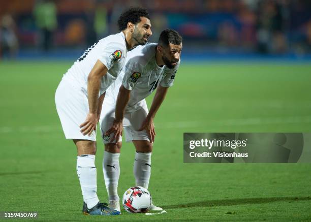 Mohamed Salah of Egypt waits with Abdallah El Said beofre taking a free-kick during the 2019 Africa Cup of Nations Group A match between Uganda and...