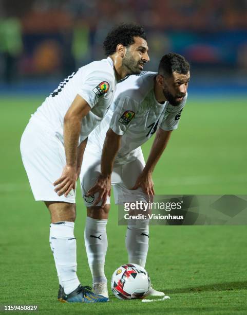 Mohamed Salah of Egypt waits with Abdallah El Said beofre taking a free-kick during the 2019 Africa Cup of Nations Group A match between Uganda and...