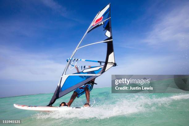 a windsurfer racing through the water. - vindsurfing bildbanksfoton och bilder