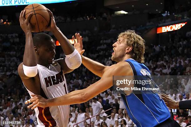 Chris Bosh of the Miami Heat drives against Dirk Nowitzki of the Dallas Mavericks in the first half of Game Six of the 2011 NBA Finals at American...