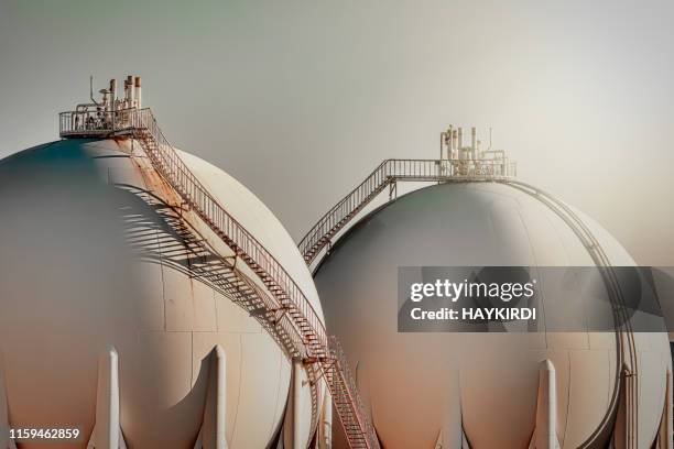 sphere gas tanks in refiney plant - natural gas stock pictures, royalty-free photos & images