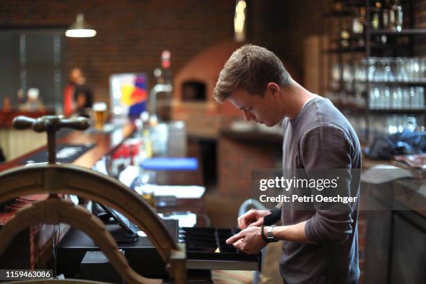 a restaurant manager using the cash register. - cash register stock pictures, royalty-free photos & images