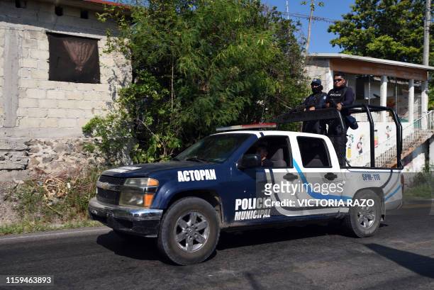 Police officers stand guard outside the house of late journalist Celestino Ruiz in Actopan, Veracruz, Mexico, on August 3, 2019. - Ruiz, who worked...