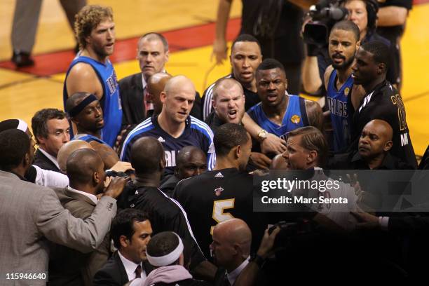 Dirk Nowitzki, Jason Terry, Brian Cardinal and DeShawn Stevenson of the Dallas Mavericks confront players from the Miami Heat including Juwan Howard...