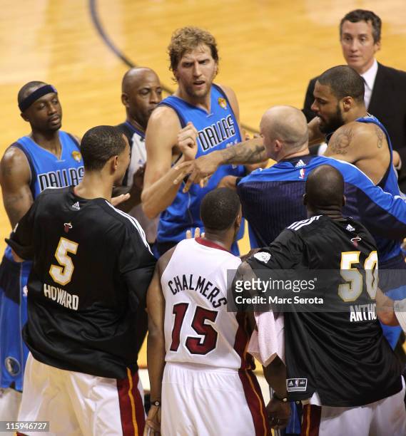 Jason Terry, Dirk Nowitzki and Brian Cardinal of the Dallas Mavericks attempt to seperate teammate Tyson Chandler of the Dallas Mavericks and Juwan...