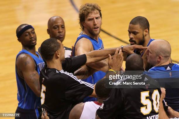 Jason Terry , Dirk Nowitzki and Brian Cardinal of the Dallas Mavericks attempt to seperate teammate Tyson Chandler of the Dallas Mavericks and Juwan...