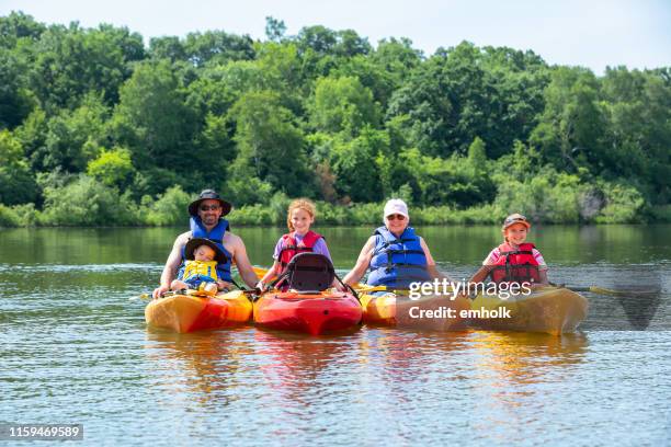 family kayaking at the lake in summer - family kayaking stock pictures, royalty-free photos & images