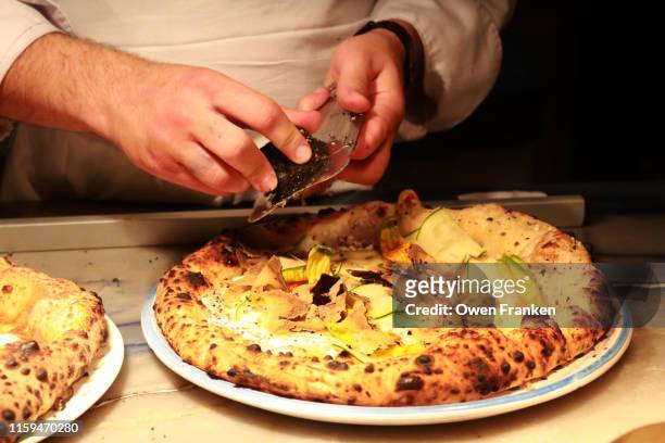 the final preparation of foods before being picked up by the servers, in an italian restaurant in paris - paris flood stock-fotos und bilder