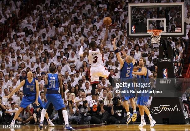 Dwyane Wade of the Miami Heat drives for a shot attempt against Brian Cardinal, Jason Terry, Jason Kidd and Dirk Nowitzki of the Dallas Mavericks in...