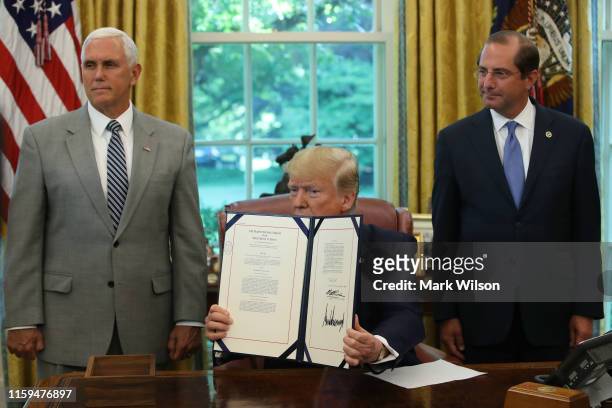 President Donald Trump speaks to the media after signing a bill for border funding legislation while flanked by Vice President Mike Pence and Health...