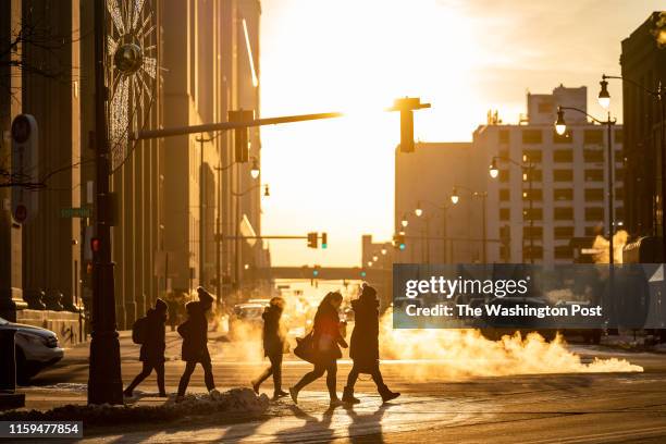 Detroit, MI People cross Michigan Avenue in Downtown Detroit in the evening.