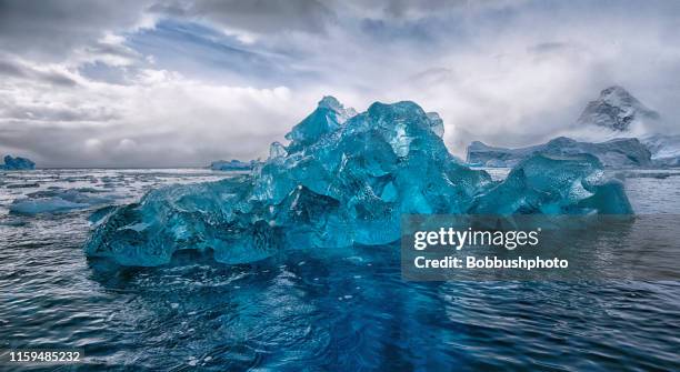 blue iceberg in antarctica - berg stock pictures, royalty-free photos & images