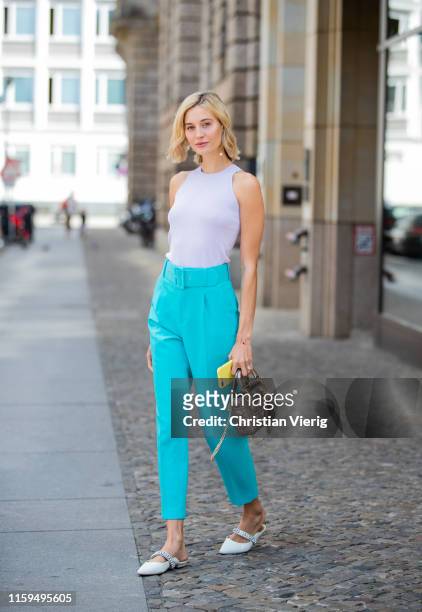 Mandy Bork is seen wearing turquois pants and white top Zara, Dior bag, Cartier and Dior jewellery, Kurt Geiger shoes during Mercedes Benz Fashion...